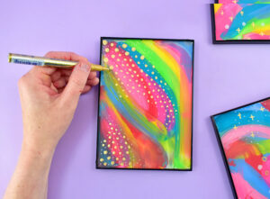 With the glass back in place, trace the gold designs on top of the glass.