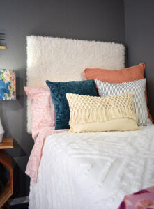 This DIY furry headboard is super easy to make and so comfy to rest against. Add some fun bohemian flair to your bed with a faux fur headboard!