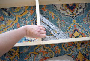 With the back side still facing up measure from one end and mark these measurements on both sides: 10.75", 21.75", 32.25", 43", 53.75". These marks correspond with the placement of the TOP edge of your shelves.