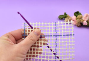 Push your hook up through the rug canvas.