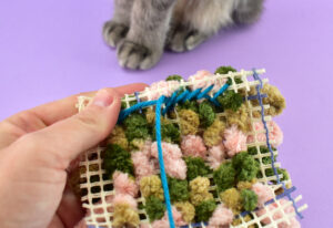 Make sure your needle goes into the loops of the rug for a nice, tight hold. Though it feels like your yarn will be visible through the top, it should not be.