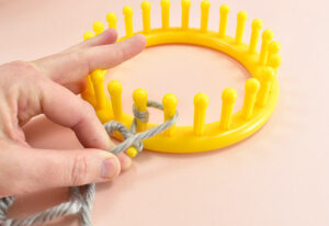 Wrap around the next peg, and each peg around in a clock-wise.