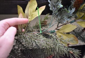 Zip ties are a great option for adding heavier florals to your DIY Christmas garland. Simply place the stem where you would like for it to connect with the garland and secure as tightly as possible with the zip tie. Trim the tie's tail.