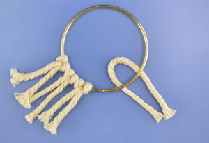 Fold the cord in half and place the looped end inside under the hoop.