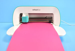 If cutting your ruler from vinyl, download the free ruler ZIP file that contains the free SVG file. Cut on the machine of your choice and weed. Apply transfer tape over the top of the design and apply pressure to transfer the vinyl to the tape. Place the vinyl and transfer tape on top of your 20" piece of wood, centering it as well as you can. Place down and apply pressure to transfer the ruler design.