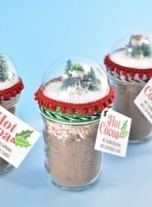Looking for an adorable and fun gift to give this winter? Fill Snow Globe Mason Jars with our Hot Cocoa Recipe. So easy, so sweet!