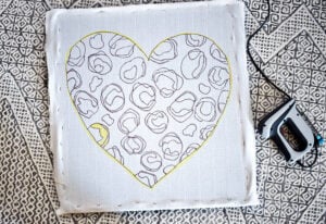 Stretch the monk's cloth across the frame and use a staple gun to staple in place. You want the monk's cloth to be nice and tight.