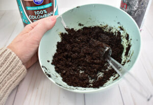 Add 1/4 cup of coffee grounds to the glue mixture and stir well. The resulting dirt will be wet but not sloppy. When a small amount is pressed between your fingers it should easily clump into a solid piece.