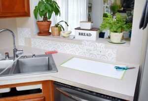 Starting in that first corner stick your tile so that the side runs along the seam where the 2 corners meet and the bottom runs along the counter. How far apart you want to place these is totally dependent on the width you want your "grout lines". I wanted small lines and so mine are pretty close to the bottom and the corner.