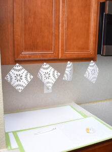 For me, I was able to hang 8 tiles to my upper cabinets like you see here.