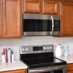 Want to update your kitchen on a budget? See how we made our own DIY peel and stick backsplash tile for a whole new look!