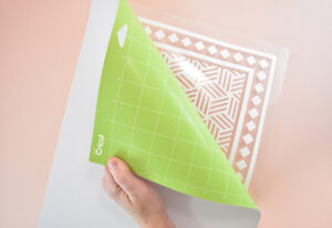 Flip your mat over onto your work surface and pull the mat away from the Iron-On to separate.