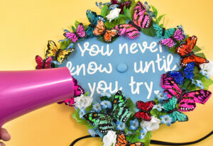 Take a regular blow dryer and turn it onto the "hot " setting if necessary. Using the lowest speed available, go over the design, concentrating on the glue strings. As they heat up they should break, curl up, and disappear!