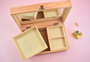 This DIY Musical Jewelry Box with Veneer Inlay Design is made using this specific unfished wood jewelry box available at Amazon. You can use any music box you'd like but I'd look for one that has a lip around the top of the lid for the design to fit neatly within. You also need a box with removable trays inside so that you can hide away the little metal music mechanism.