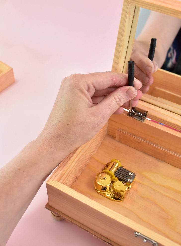Put the jewelry box back together, screwing the lid and base together with the hinges.