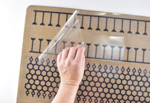 When the full design is in place and the carrier sheet has cooled, gently peel the clear sheet away. Go slowly and if any of the Iron-On is not fully adhered to the rug replace the full sheet and apply heat to the section of the design to tack it down. Gently and slowly peel the warm carrier sheet and if the design sticks move on to the next!