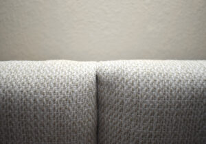 Pull and finagle the second corner to overlap while making the smallest possible crease.