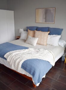 Dressed bed before hanging my new, DIY channel tufted headboard.
