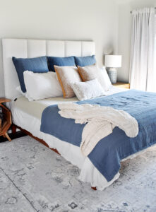 It's so easy to make a DIY Channel Tufted Headboard in any size! Get our full tutorial and save money and cozy up your bedroom at the same time!