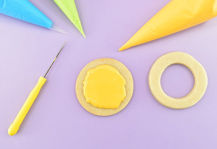 Pipe your colored royal icing into the center of the cookie just barely beyond the line you drew. Or, if you don't have edible markers, just kind of wing it. Just keep the icing from getting too close to the edge so that it doesn't squeeze out.