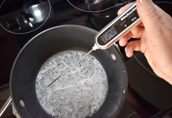 Measure out 1 cup of isomalt crystals and transfer to a heavy bottomed pan or a Pyrex glass measuring cup. Pour in about one tablespoon of distilled water and stir. Your isomalt should be wet similar to wet sand on the beach. Add more water if necessary.
