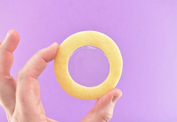 Quickly peel the foil away from the cookie to keep the sugar glass nice and clear. If it is cloudy you can use a kitchen torch to carefully melt the underside of the isomalt until it becomes clear and shiny again.