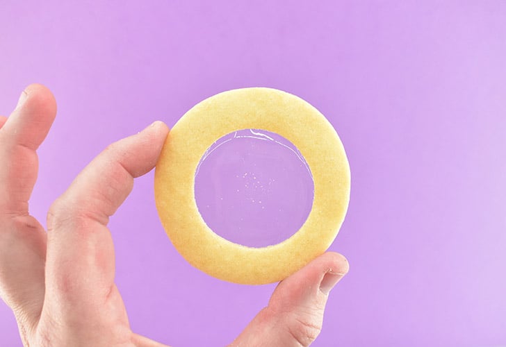 Quickly peel the foil away from the cookie to keep the sugar glass nice and clear. If it is cloudy you can use a kitchen torch to carefully melt the underside of the isomalt until it becomes clear and shiny again. 