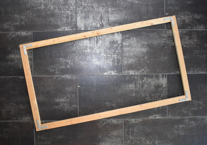 Rather than cutting the frame to have fancy mitered (angled) sides that fit together, simply straight cut. 