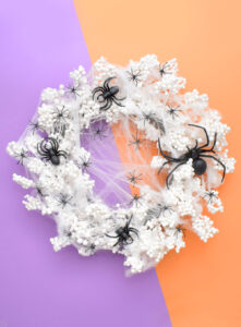 This amazing Spiderweb Halloween Wreath comes together in minutes and requires no glue. Get the spooky & sinfully simple DIY!