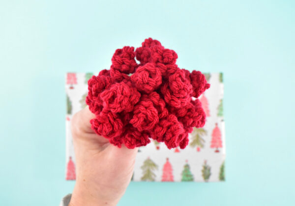 This adorable crochet curly bow pattern is easy, super quick, and an amazing stash buster. Use them for the cutest pompoms for hats or to embellish wrapped gifts!