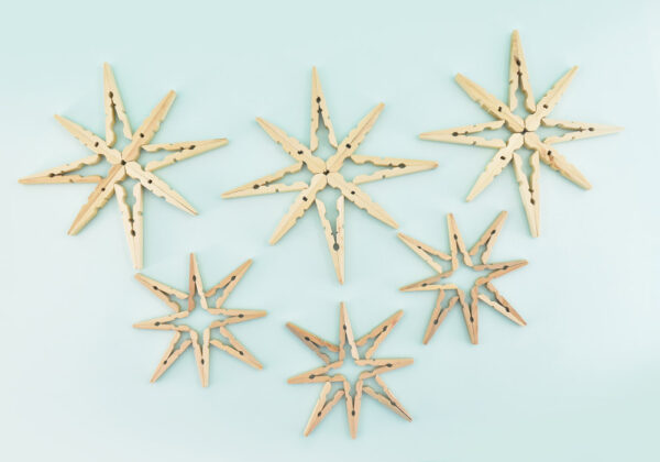 The bottom design has the fat ends of the pins meet in the middle. The top, smaller design is open in the center. The 2 designs stacked make a little nest to hold the gold glitter balls so that they don't roll away.