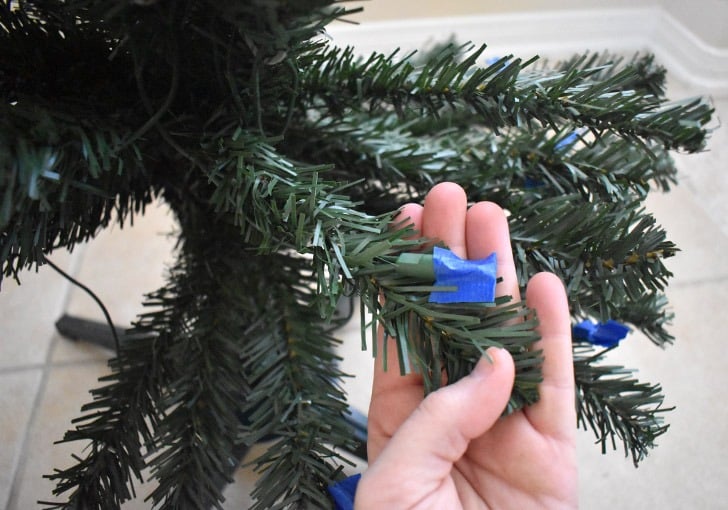 If your Christmas tree is pre-lit, you'll need to protect the lights from getting covered and obscured by the flocking.