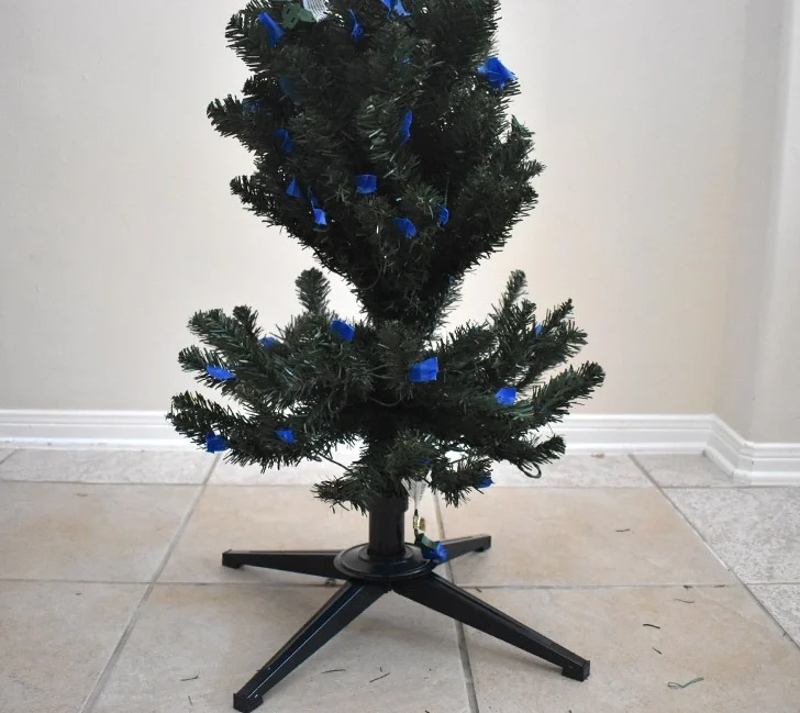 Starting with the first, lowest section of your tree, fluff out the branches and move them where they look best. After flocking it's more difficult to move things around, so be sure you're happy with how the branches look.