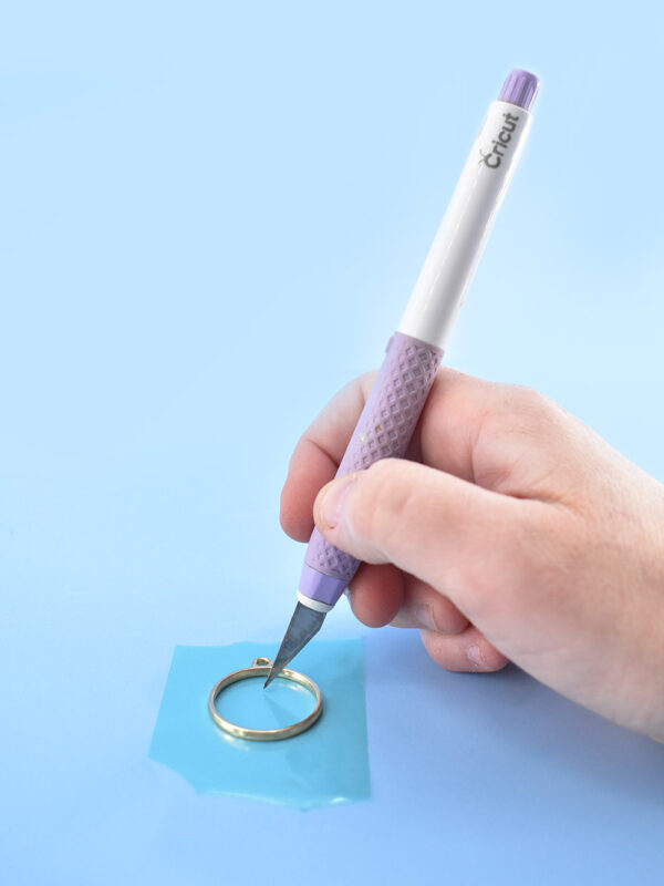 Pop bubbles and remove debris from wet resin prior to curing using a craft knife.