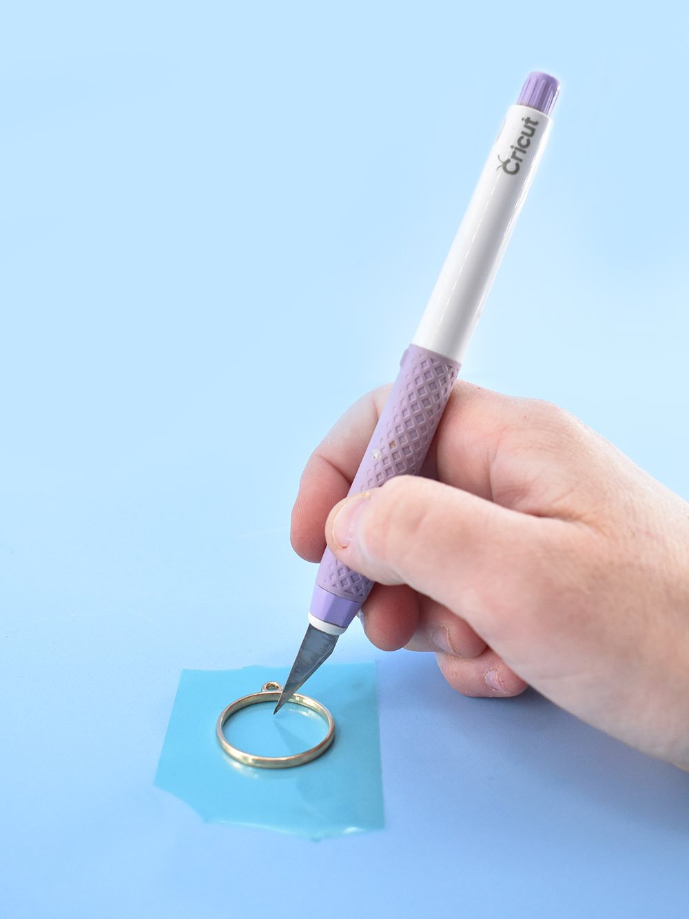 Pop bubbles and remove debris from wet resin prior to curing using a craft knife.
