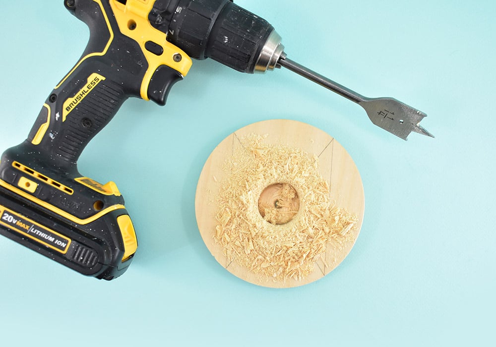 Place a 1-1/4" spade drill bit into your power drill. Place the point of the bit right onto the center of that "X" you drew. Hold the drill nice and straight and drill a 1 1/4" circle right smack dab in the center. 