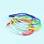 DIY noodle bead stacking bracelets can be made in any color for any outfit. No fancy jewelry tools or experience required!