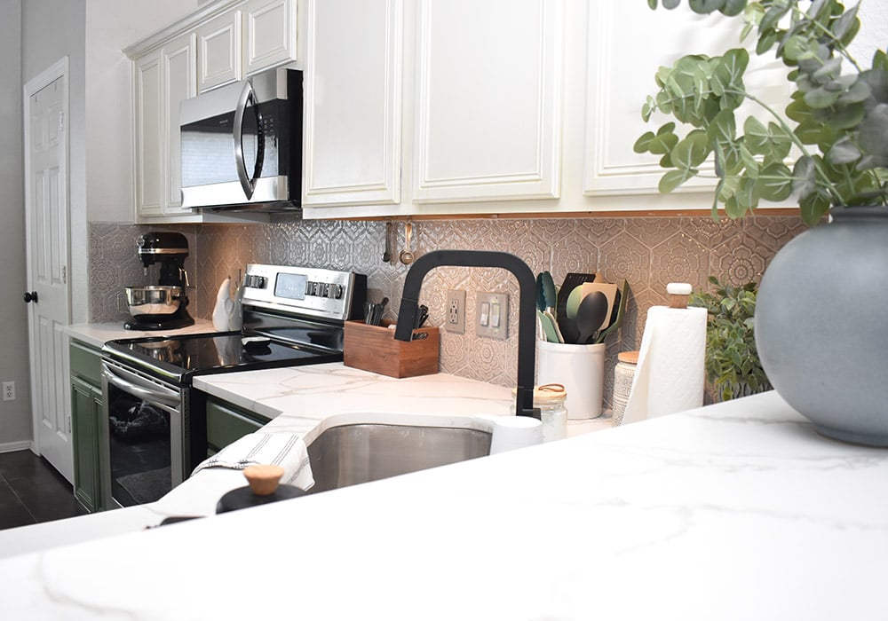 Want to update your kitchen on a budget? See how we made our own DIY peel and stick backsplash tile for a whole new look! See how well it lasted after 2 years of heavy use!