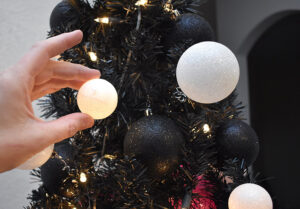 Place the ornament over a light from the tree. It should be a snug fit, but if it is not, a hot glue lip around the opening will tighten the fit. Do not, hot glue the ornaments to the lights/tree unless you're only ever going to use it for a galaxy tree.