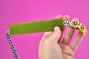 Cut a piece of felt that is 3x the width of your collar. Fold it over your collar in half and then carefully glue just the edge down, avoiding applying glue to the collar itself.